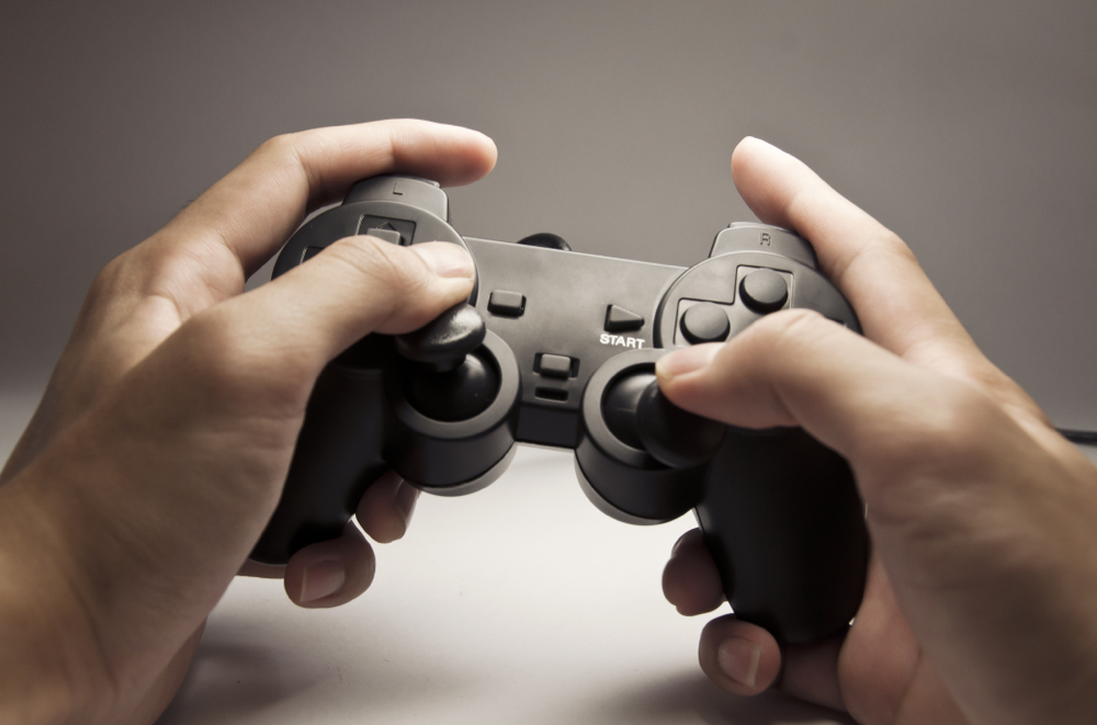 Man Holding Sony Playstation Controller