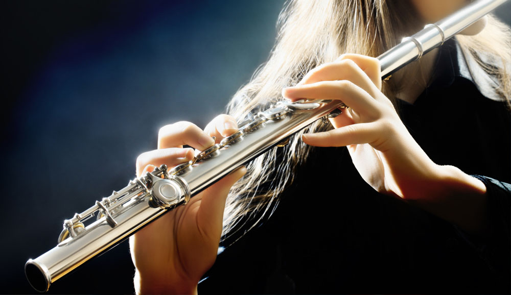 Blond Woman Playing A Flute